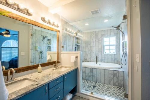 a bathroom with two sinks and a tub and a shower at Duke's Hawaiian Surf Haven in Pleasant Grove