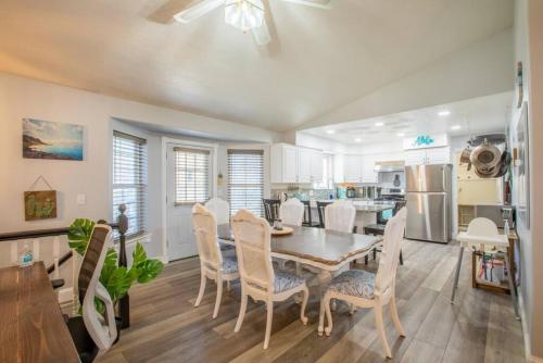 a kitchen and dining room with a table and chairs at Duke's Hawaiian Surf Haven in Pleasant Grove