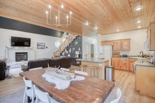 a kitchen and living room with a wooden ceiling at Bills Island Hideaway in Island Park