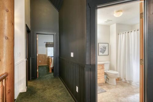 a bathroom with black walls and a toilet in it at Bills Island Hideaway in Island Park