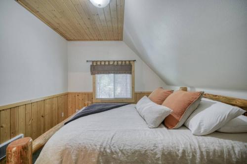a bedroom with a bed with pillows and a window at Bills Island Hideaway in Island Park