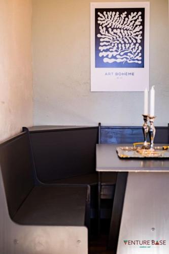 a table with two candles and a picture on the wall at Trailblazer's Retreat, Venture Base Unit 3 in Kanab