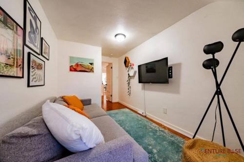 a living room with a couch and a flat screen tv at Trailblazer's Retreat, Venture Base Unit 3 in Kanab