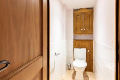 La salle de bains est pourvue de toilettes et d'une armoire en bois. dans l'établissement Résidence Les Alpages de Chantel - maeva Home - Appartement 3 Pièces 6 Personnes - Sélection MAE-1650, à Bourg-Saint-Maurice