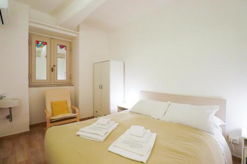 ローマにあるCasa Isideのベッドルーム1室(ベッド1台、タオル2枚付)