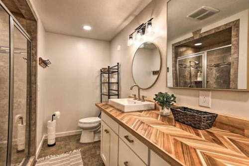 a bathroom with a sink and a toilet and a mirror at Riverview Retreat in Idaho Falls
