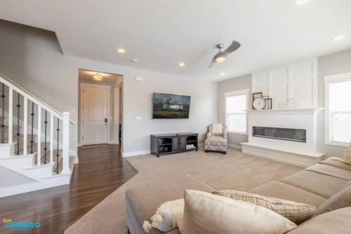 a living room with a couch and a fireplace at Oquirrh Mountain Haven in South Jordan