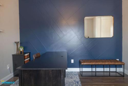 a room with a bench and a blue wall at Oquirrh Mountain Haven in South Jordan
