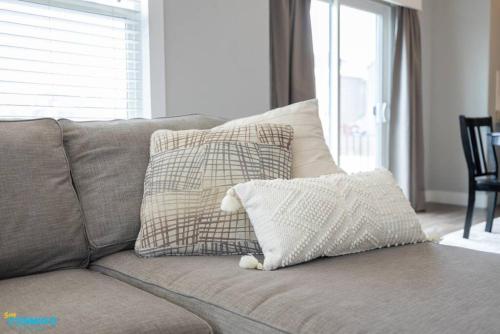 a couch with pillows on it in a living room at Oquirrh Mountain Haven in South Jordan