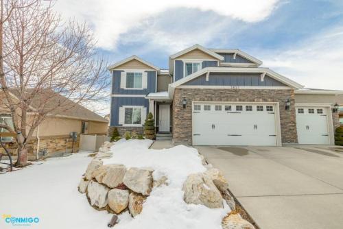 a large blue house with a garage at Oquirrh Mountain Haven in South Jordan