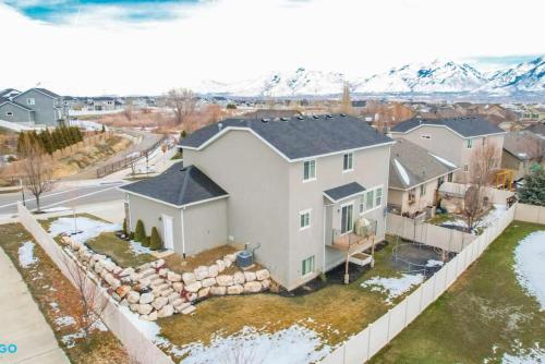 an aerial view of a white house with mountains in the background at Oquirrh Mountain Haven in South Jordan