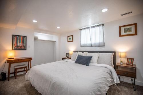 a bedroom with a large white bed and a desk at Lily Pad in Sandy