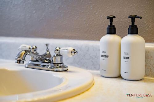 two bottles of soap are sitting on a bathroom sink at Wanderlust Hideaway, Venture Base Unit 1 in Kanab