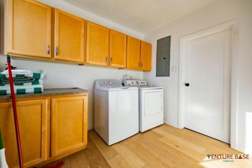 a kitchen with a white refrigerator and a washer at Wanderlust Hideaway, Venture Base Unit 1 in Kanab