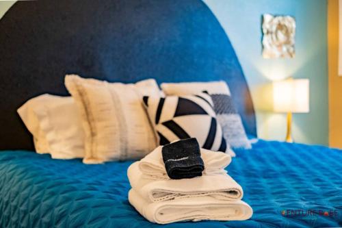 a pile of towels sitting on top of a bed at Wanderlust Hideaway, Venture Base Unit 1 in Kanab