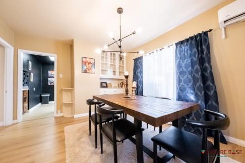 a dining room with a wooden table and black chairs at Wanderlust Hideaway, Venture Base Unit 1 in Kanab