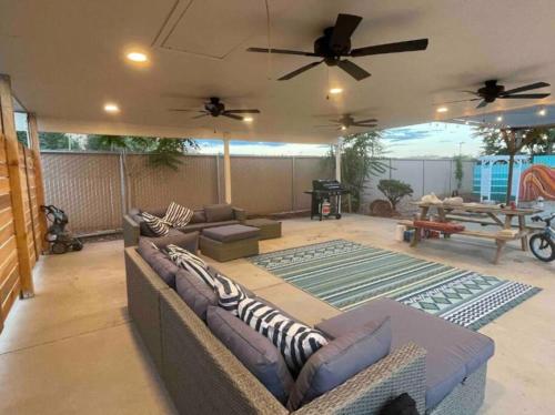 a living room with couches and a table on a patio at Wanderlust Hideaway, Venture Base Unit 1 in Kanab
