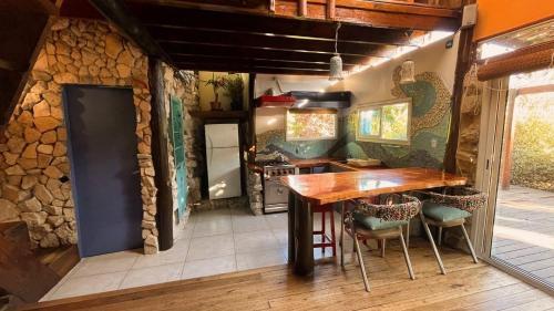 a kitchen with a wooden table and chairs at Cabaña Costa Azul Los Acantilados in Mar del Plata