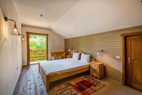a bedroom with a bed and a wooden wall at Chiba in Timisul de Jos