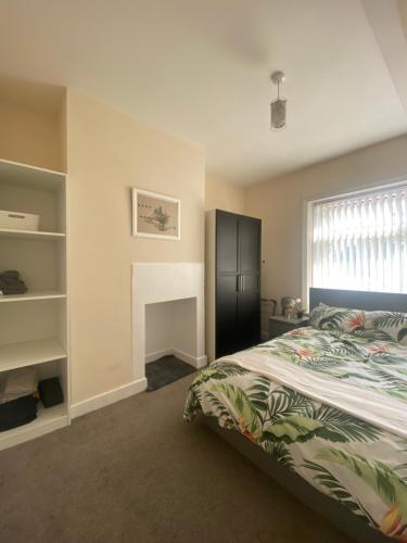 een slaapkamer met een bed en een raam bij Stylish 2 bedroom home in Cleckheaton