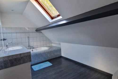 a bathroom with a sink and a bath tub at Un moment de partage au Gabizos. in Geu