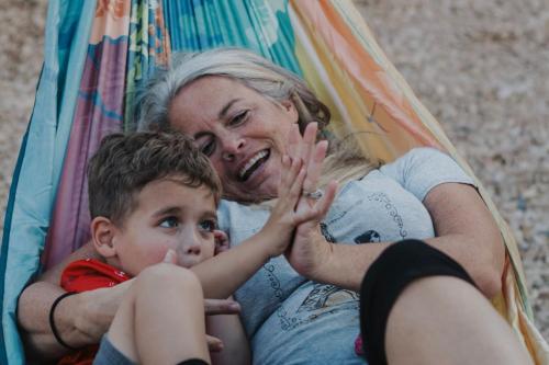 a woman and a child sitting in a hammock at Lake House Escape, Venture Base Unit 7 in Kanab