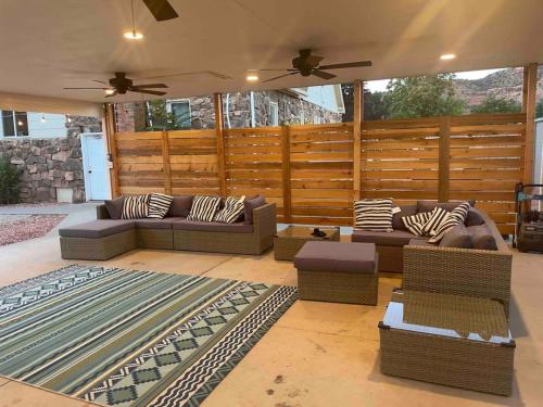 a living room with couches and chairs in front of a fence at Lake House Escape, Venture Base Unit 7 in Kanab