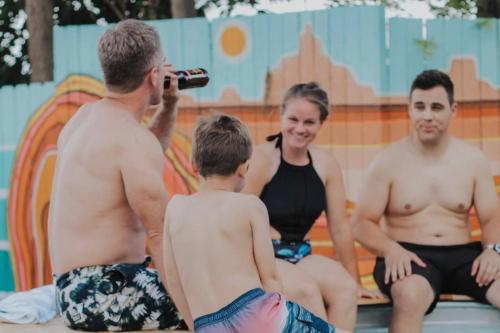 a woman taking a picture of a group of people at a swimming pool at Lake House Escape, Venture Base Unit 7 in Kanab