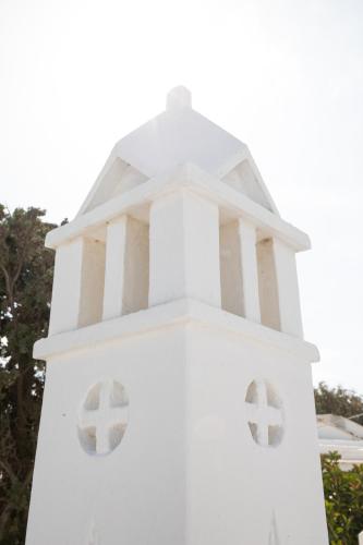 a white clock tower with two windows on it at Spitarona Town House - Largest VIlla in the Center in Mýkonos City