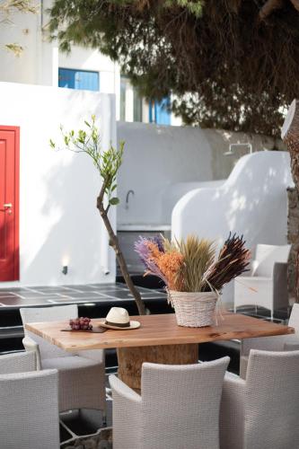 a wooden table and chairs on a patio at Spitarona Town House - Largest VIlla in the Center in Mýkonos City