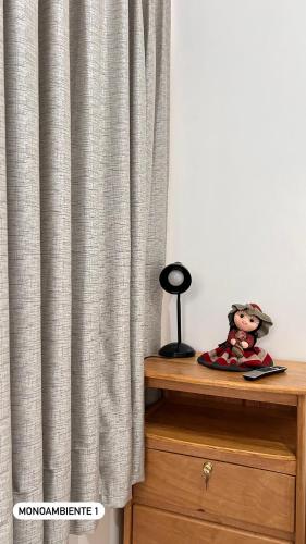 a curtain on a dresser with a doll on it at El Viejo Roble in Cusco
