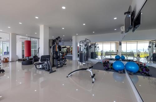 a gym with treadmills and equipment in a building at Blue Elephant Villa Koh Phangan in Haad Pleayleam