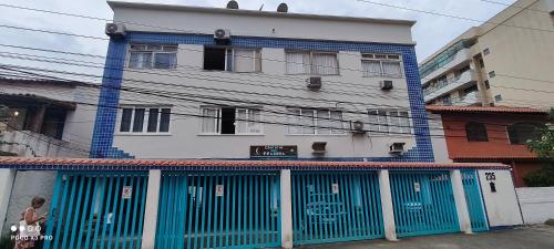 a building with blue doors in front of it at Ap a 50m da Prainha em Arraial in Arraial do Cabo