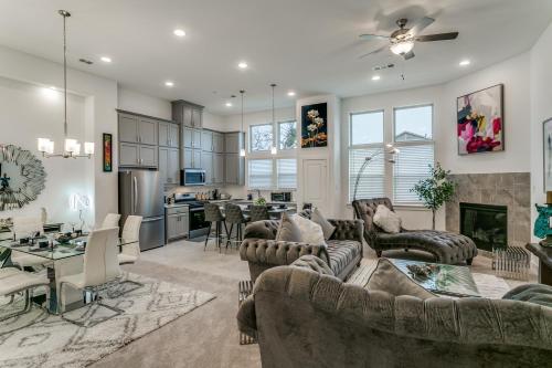 a large living room with couches and a kitchen at Home away from home in Lewisville