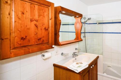 a bathroom with a sink and a mirror at Résidence Les Hauts Bois - maeva Home - Appartement 4 Pièces 8 Personnes - 82 in Aime-La Plagne