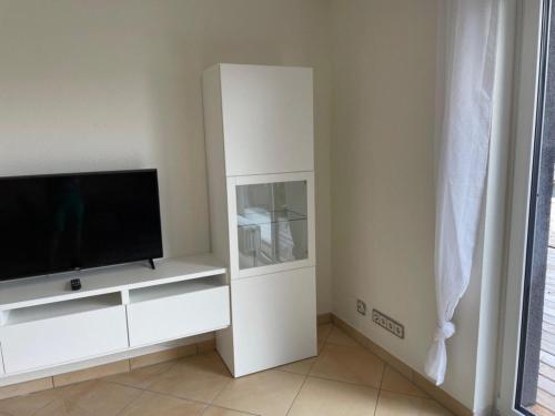 a white entertainment center with a flat screen tv at Ferienwohnung Lara in Bad Breisig
