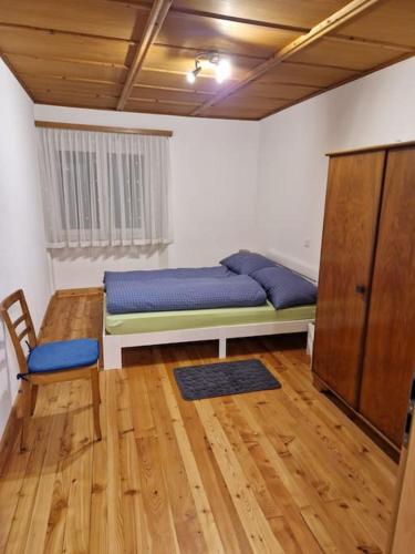 a room with a bed and a cabinet in it at Appartamento di vacanza in Poschiavo