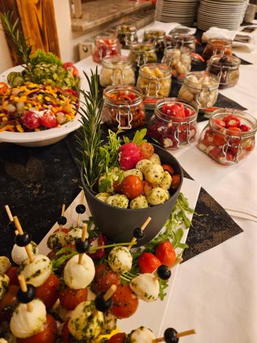 a table with many different types of food on it at Hotel-Restaurant Thüringer Hof in Bad Frankenhausen