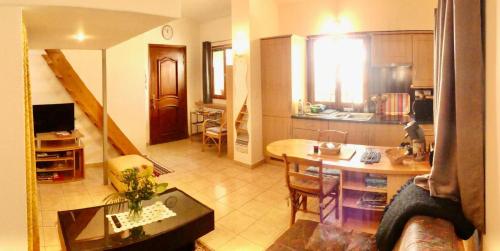 a kitchen and a living room with a table and a dining room at Les Mimosas in Biot