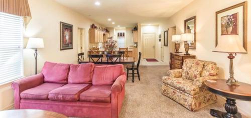 a living room with a purple couch and a table at Branson Condo with a Walkout and Elevator Access at Thousand Hills and next to 76 in Branson