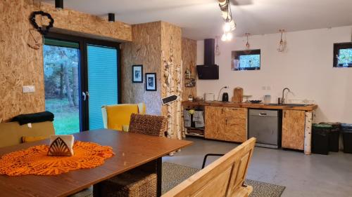a kitchen and dining room with a wooden table at Siedlisko Bolek in Nadrybie