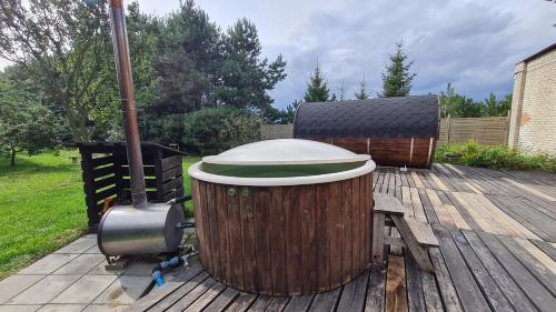 a large trash can sitting on a wooden deck at Siedlisko Bolek in Nadrybie