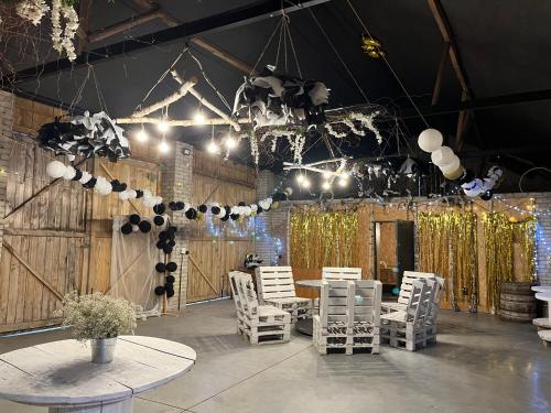 a room with a table and chairs and lights at Siedlisko Bolek in Nadrybie