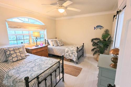 a bedroom with two beds and a window at Wake Up To The Sounds Of The Sea in Freeport