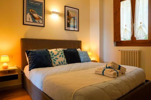 a bedroom with a bed with two towels on it at Lake Como: Bellavista apartment in Bellano