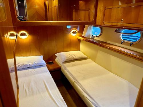 a small room with two beds and lights at Bateau - Nuit au Vieux Port in Cannes