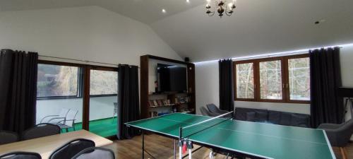 a room with a ping pong table and chairs at Penzion Zázrifka in Zázrivá