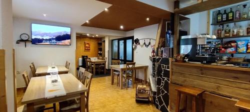 a restaurant with tables and a counter and a bar at Penzion Zázrifka in Zázrivá