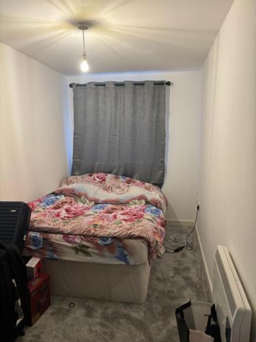 a small bedroom with a bed with a curtain at Luxury 2 Bed Apartment With Parking in Derby