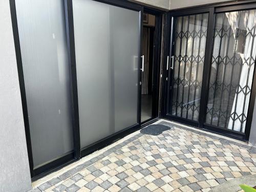 an entrance to a building with sliding glass doors at Katlego in Bloemfontein